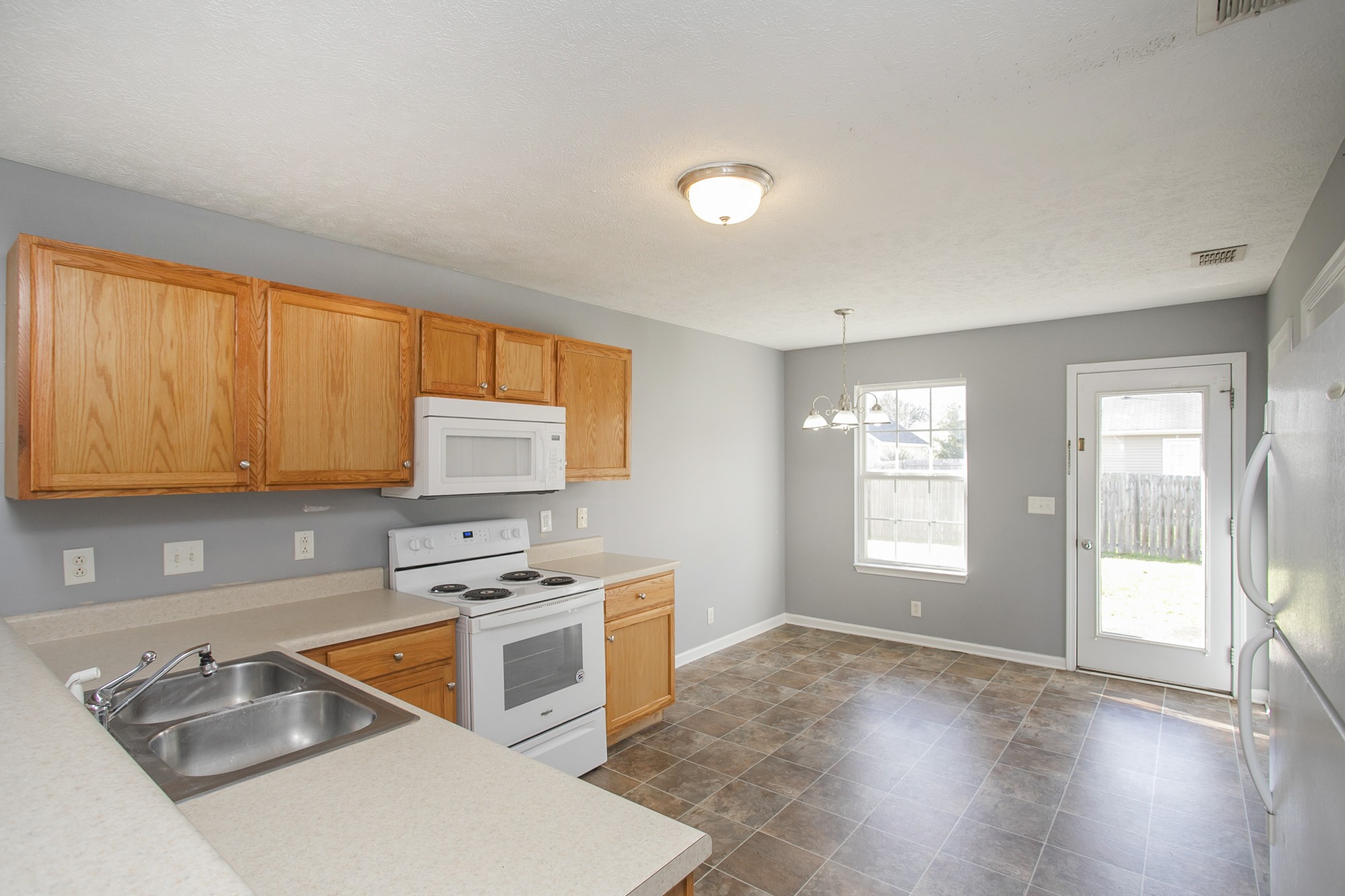 1516 Holden Court Murfreesboro, TN 37128 - Photo 5 of 23 a kitchen with stainless steel appliances granite countertop a stove a sink and a microwave
