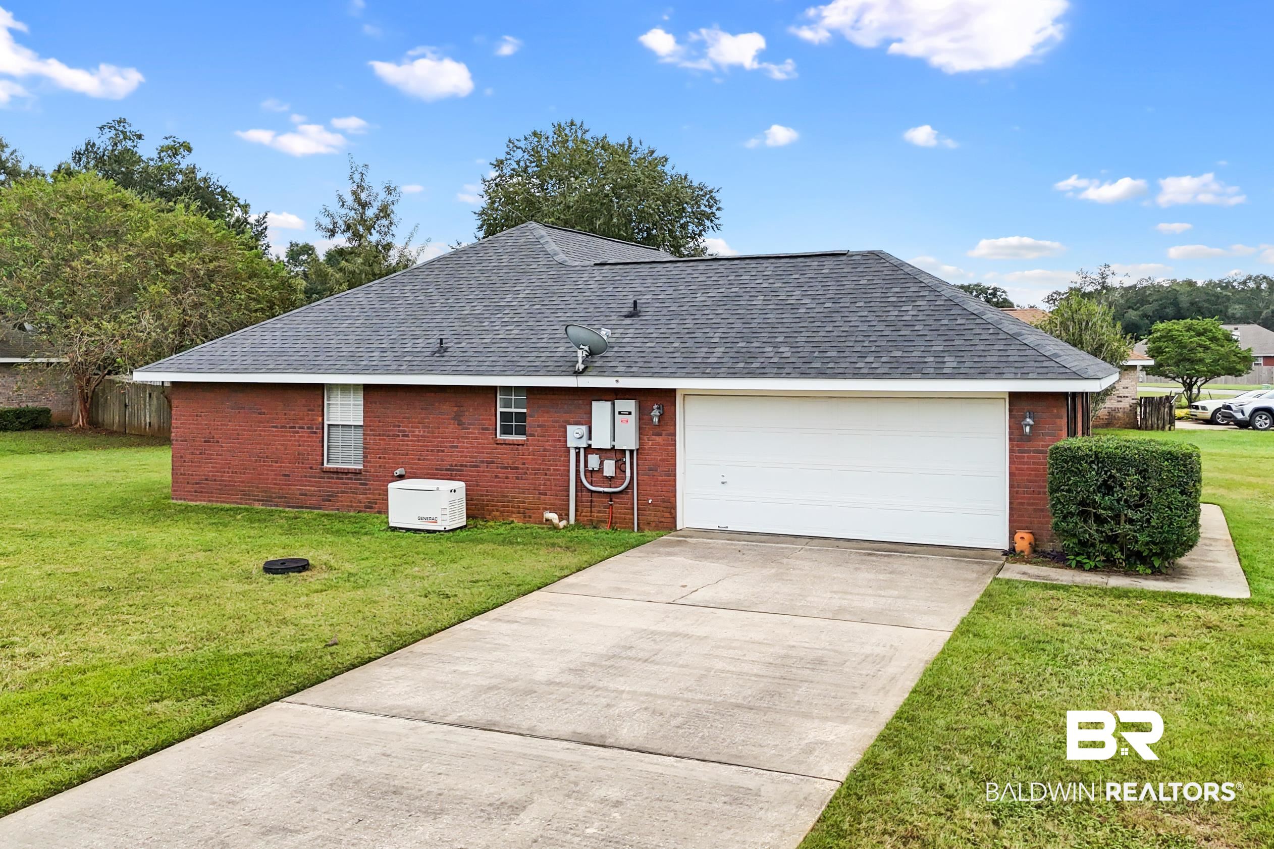 306 Monteith Oaks Drive Foley, AL 36535 - Photo 34 of 38 View of side of property featuring roof with shingles, brick siding, driveway, and an attached garage