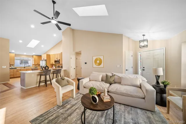 a living room with furniture and view of kitchen