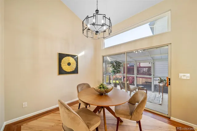 a view of a dining room with furniture and chandelier