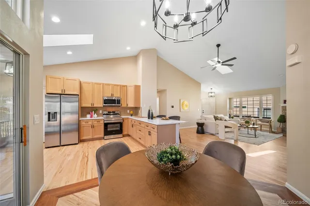 a living room with furniture kitchen and a chandelier