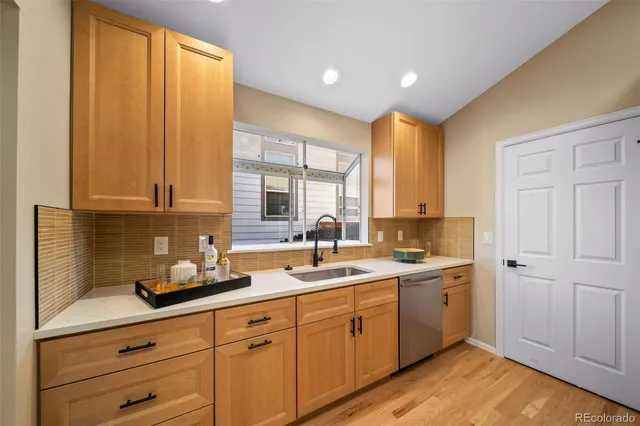 a kitchen with a sink cabinets and window
