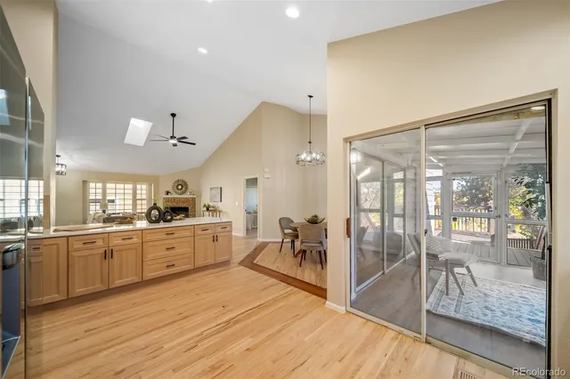 a large kitchen with kitchen island a large window and stainless steel appliances