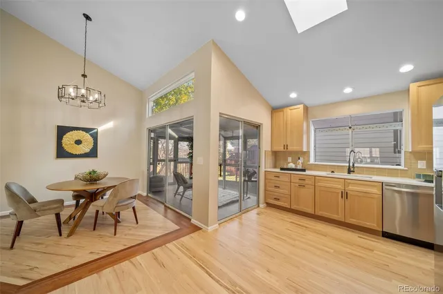 a large kitchen with stainless steel appliances kitchen island granite countertop a sink and cabinets