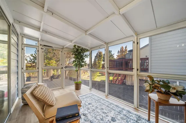 a bedroom with furniture and large windows