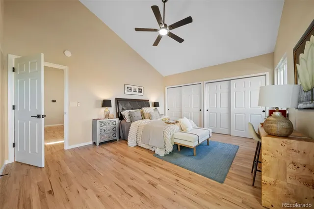 a bed room with a bed and a ceiling fan