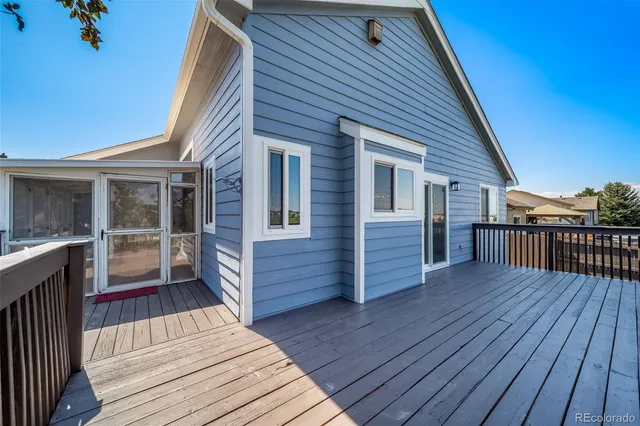 a view of a house with wooden deck