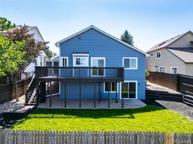 a view of a house with a yard porch and furniture