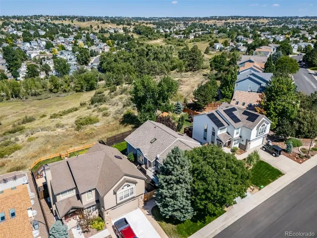 an aerial view of multiple houses with yard