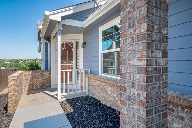 a view of a brick building next to a yard