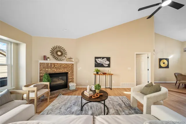 a living room with furniture and a fireplace
