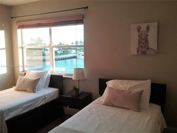 a bedroom with a bed and a lamp on table