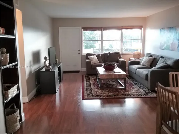 a living room with furniture window and wooden floor