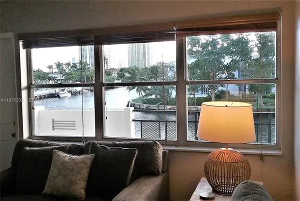 a living room with couch and large windows