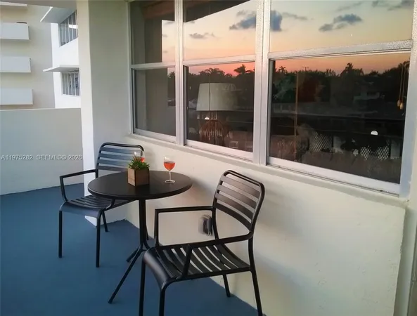 a view of a balcony with a table and chairs