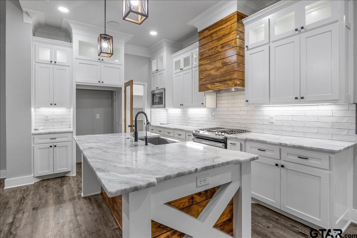 14544 Fallow Lane Lindale, TX 75706 - Photo 14 of 46 a kitchen with kitchen island granite countertop a sink cabinets and refrigerator