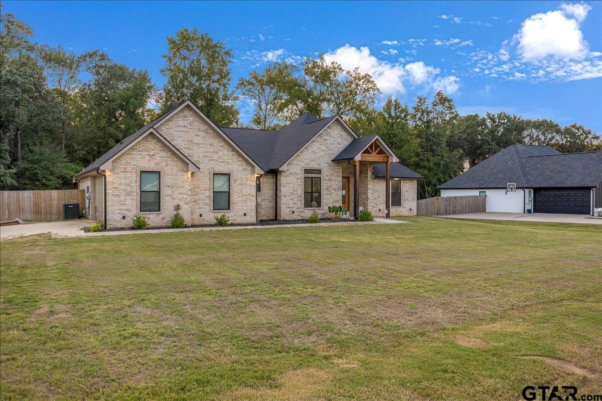 14544 Fallow Lane Lindale, TX 75706 - Photo 2 of 46 a front view of a house with a garden