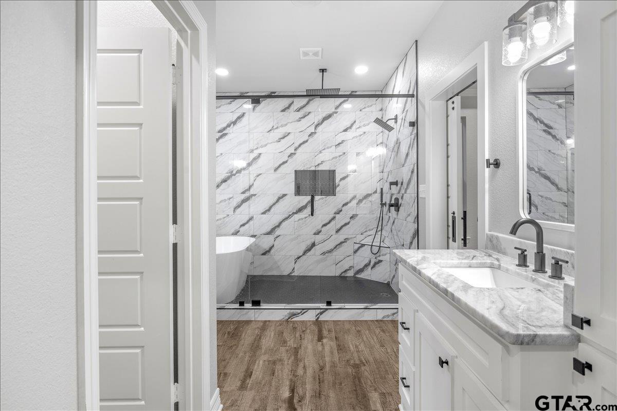 14544 Fallow Lane Lindale, TX 75706 - Photo 21 of 46 a bathroom with a granite countertop sink mirror and shower