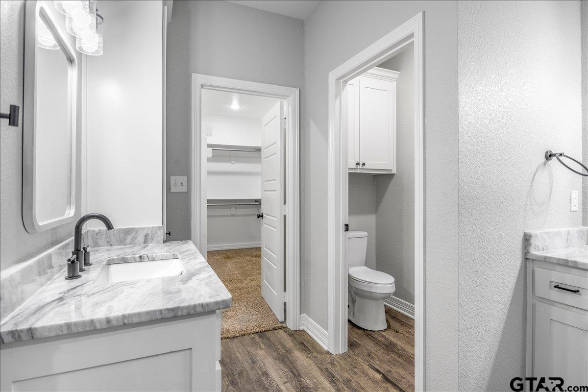14544 Fallow Lane Lindale, TX 75706 - Photo 22 of 46 a bathroom with a granite countertop sink toilet and shower a mirror