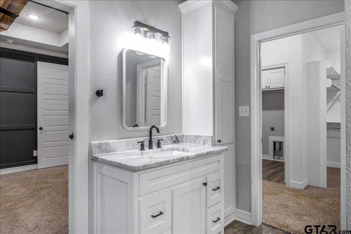 14544 Fallow Lane Lindale, TX 75706 - Photo 24 of 46 a bathroom with a granite countertop sink and a mirror