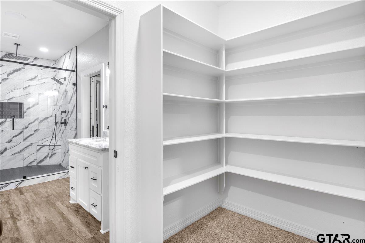14544 Fallow Lane Lindale, TX 75706 - Photo 26 of 46 a view of walk in closet with empty racks