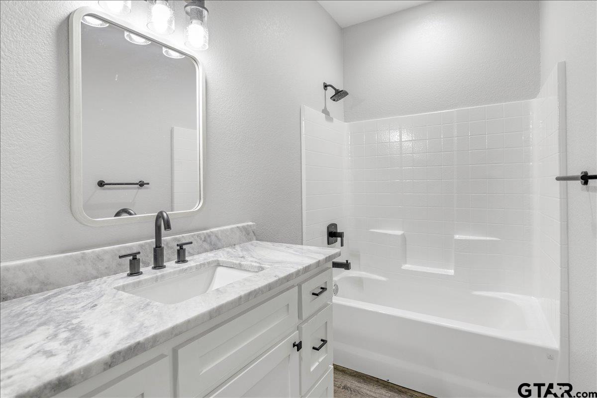 14544 Fallow Lane Lindale, TX 75706 - Photo 37 of 46 a bathroom with a granite countertop sink mirror toilet and bathtub