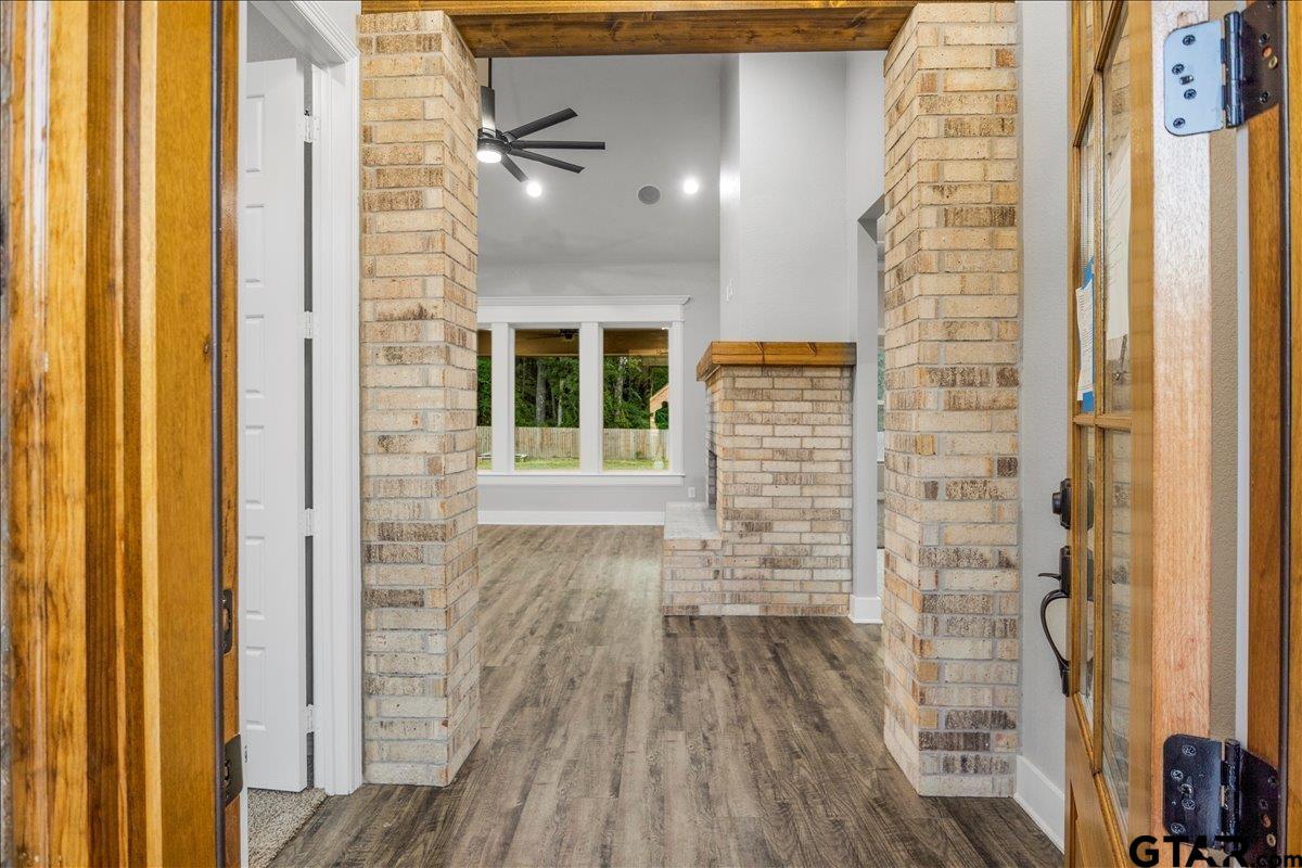 14544 Fallow Lane Lindale, TX 75706 - Photo 6 of 46 a view of a hallway with wooden floor and a bathroom