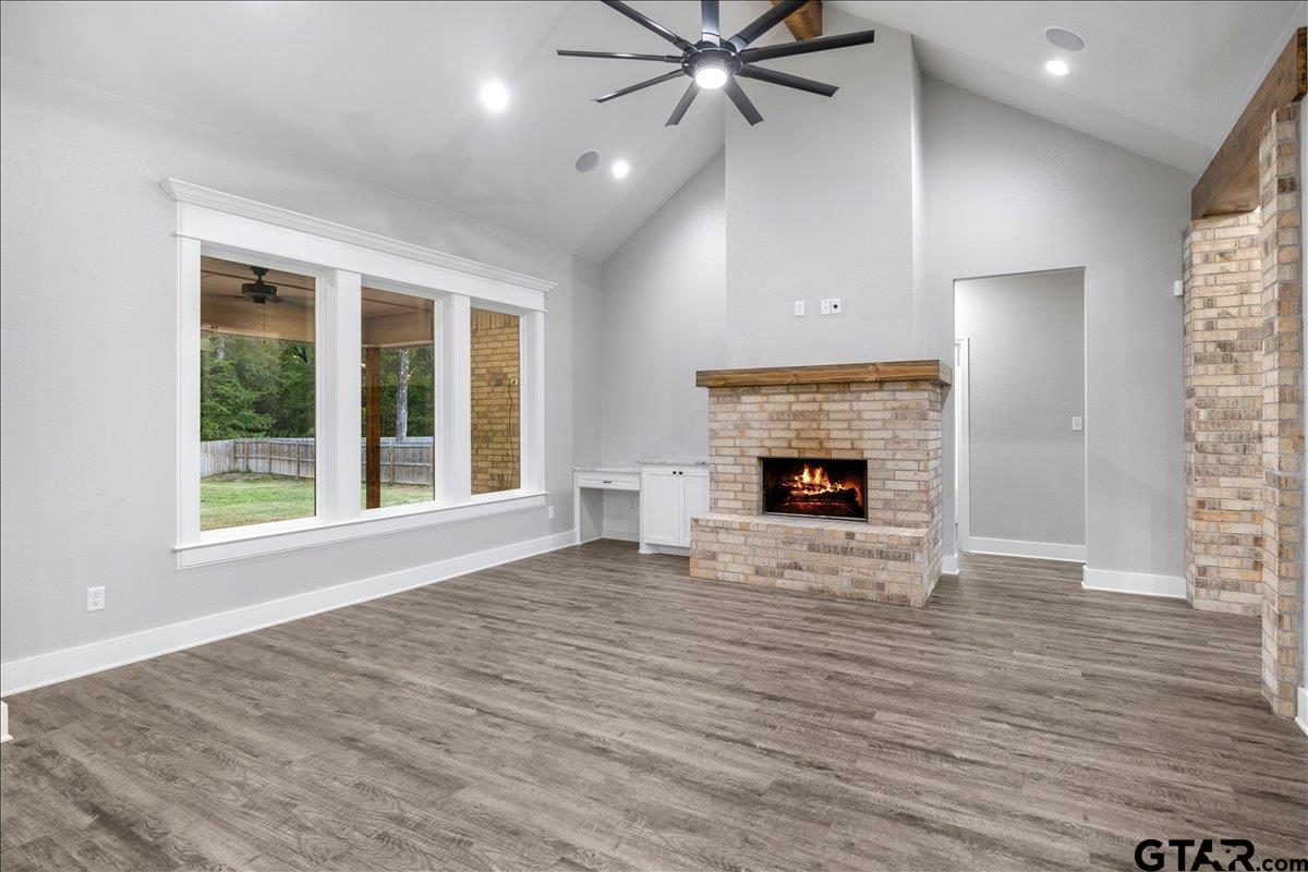 14544 Fallow Lane Lindale, TX 75706 - Photo 10 of 46 a view of an empty room with wooden floor fireplace and a window