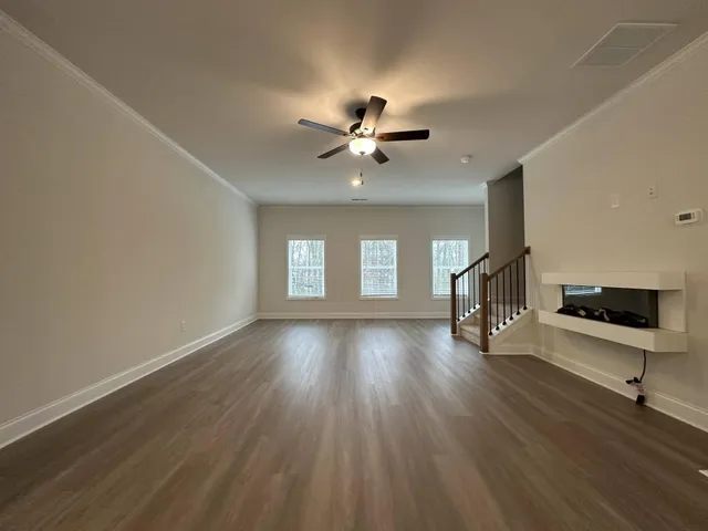 wooden floor in an empty room with a window