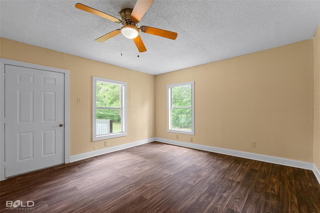 115 Pam Street Mansfield, LA 71052 - Photo 16 of 25 a view of an empty room with wooden floor and a window