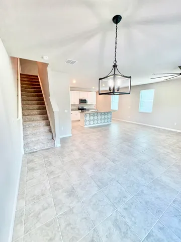 a view of a livingroom with a ceiling fan and window