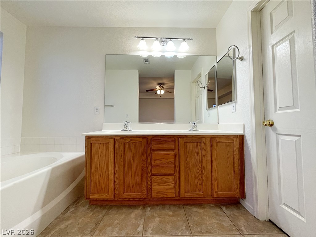 691 Principle Point Avenue Henderson, NV 89012 - Photo 21 of 30 A generous double vanity and soaking tub create a personal spa retreat.