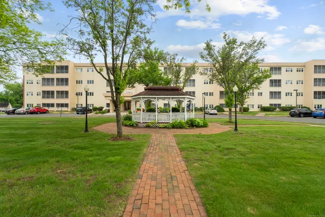 a view of residential houses with yard and green space