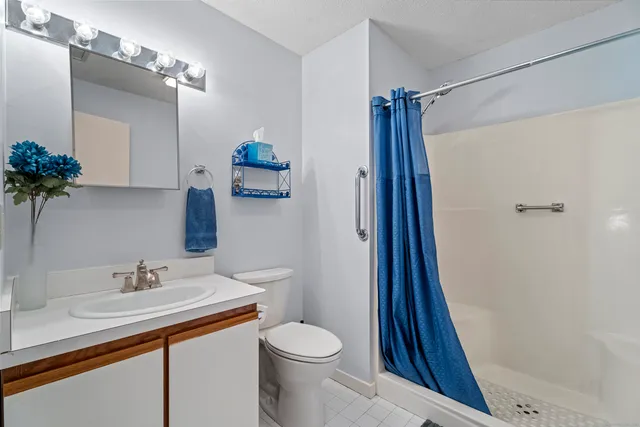 a bathroom with a sink toilet and shower