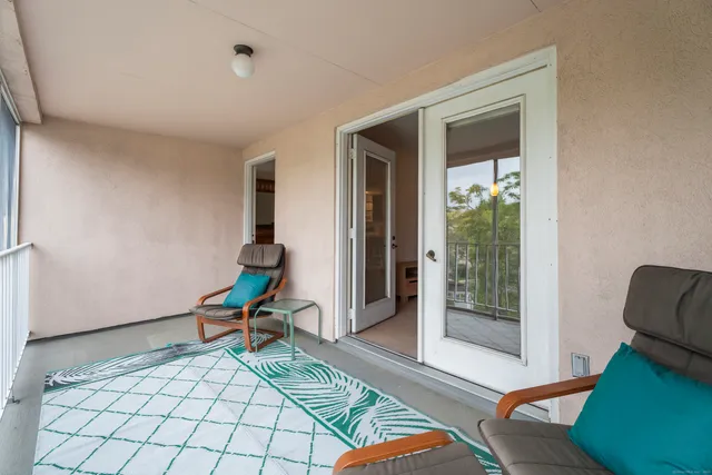 a living room with a couch and a rug floor