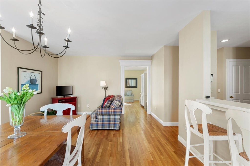 56 Brook Street, Unit B Manchester, MA 01944 - Photo 12 of 37 a bedroom with furniture and a chandelier