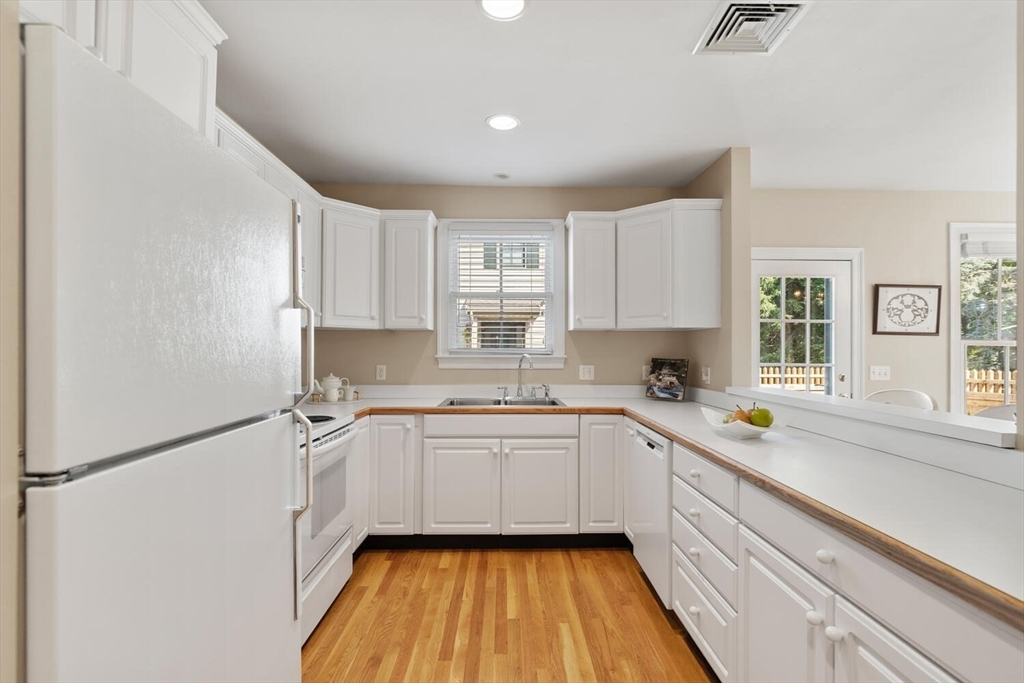 56 Brook Street, Unit B Manchester, MA 01944 - Photo 15 of 37 a kitchen with a sink stove and cabinets