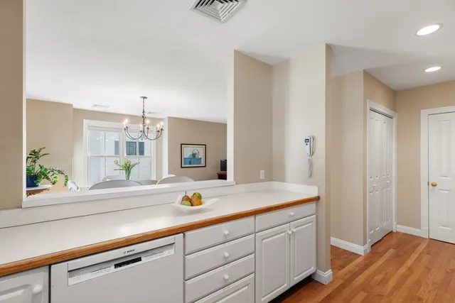 a view of kitchen with a sink and wooden floor