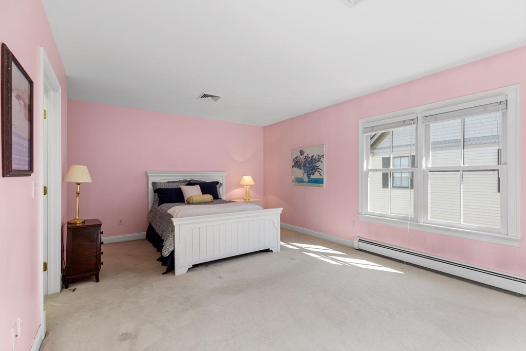 56 Brook Street, Unit B Manchester, MA 01944 - Photo 19 of 37 a bed room with a bed and a window