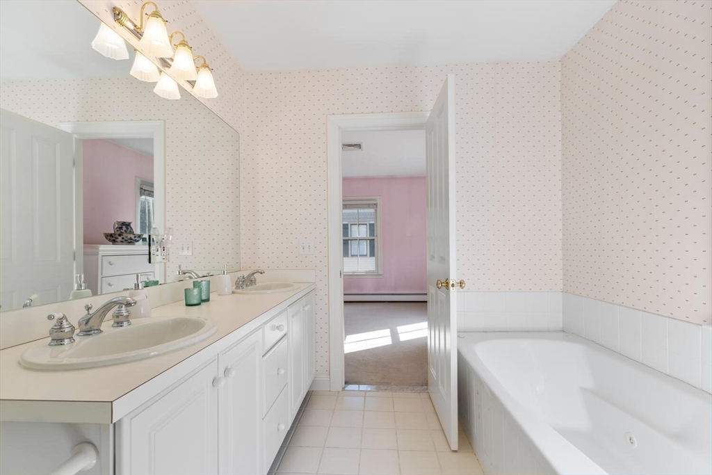 56 Brook Street, Unit B Manchester, MA 01944 - Photo 22 of 37 a bathroom with a tub a sink and mirror