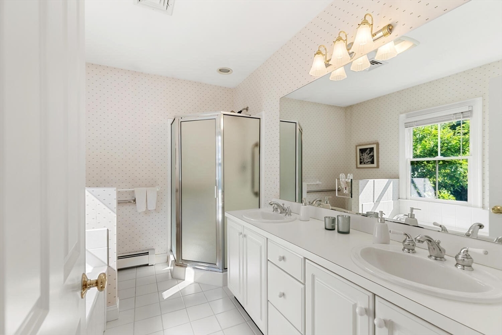 56 Brook Street, Unit B Manchester, MA 01944 - Photo 23 of 37 a bathroom with double vanity sink a two mirror a window and a shower