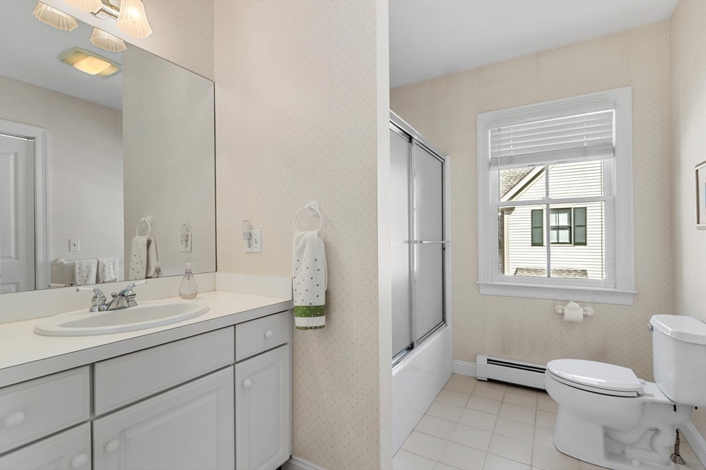 56 Brook Street, Unit B Manchester, MA 01944 - Photo 24 of 37 a bathroom with a toilet sink and mirror