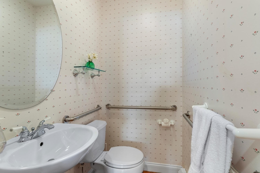 56 Brook Street, Unit B Manchester, MA 01944 - Photo 26 of 37 a white toilet sitting next to a bathroom sink