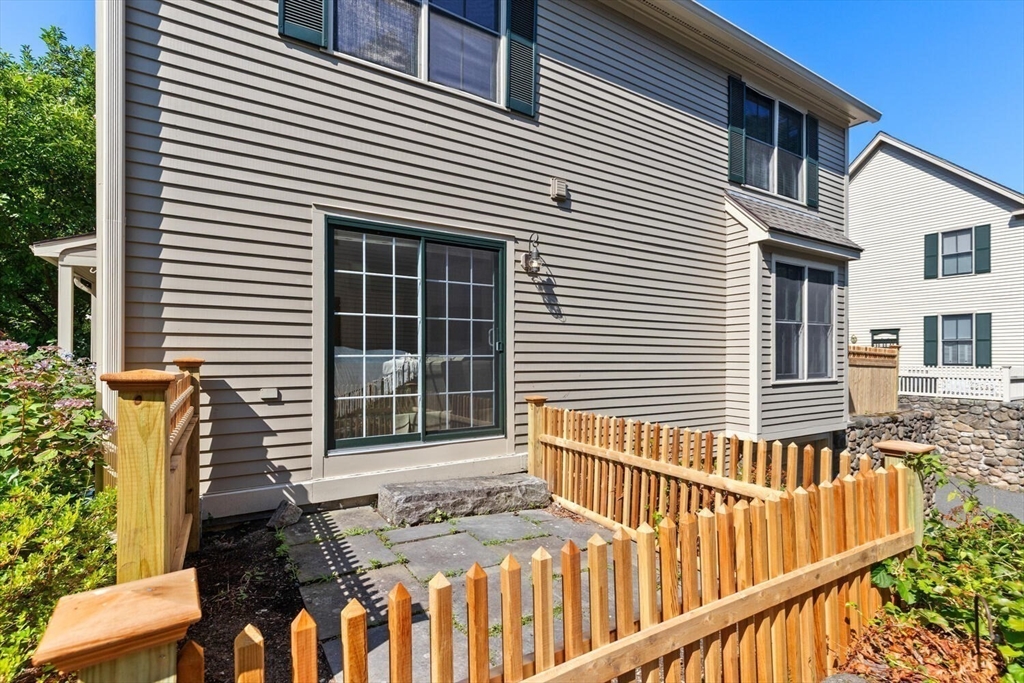 56 Brook Street, Unit B Manchester, MA 01944 - Photo 29 of 37 a view of a house with a small yard and wooden fence