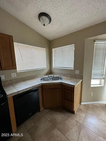 a kitchen with stainless steel appliances granite countertop a sink and a stove