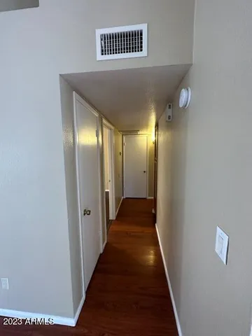 a view of a hallway with wooden floor