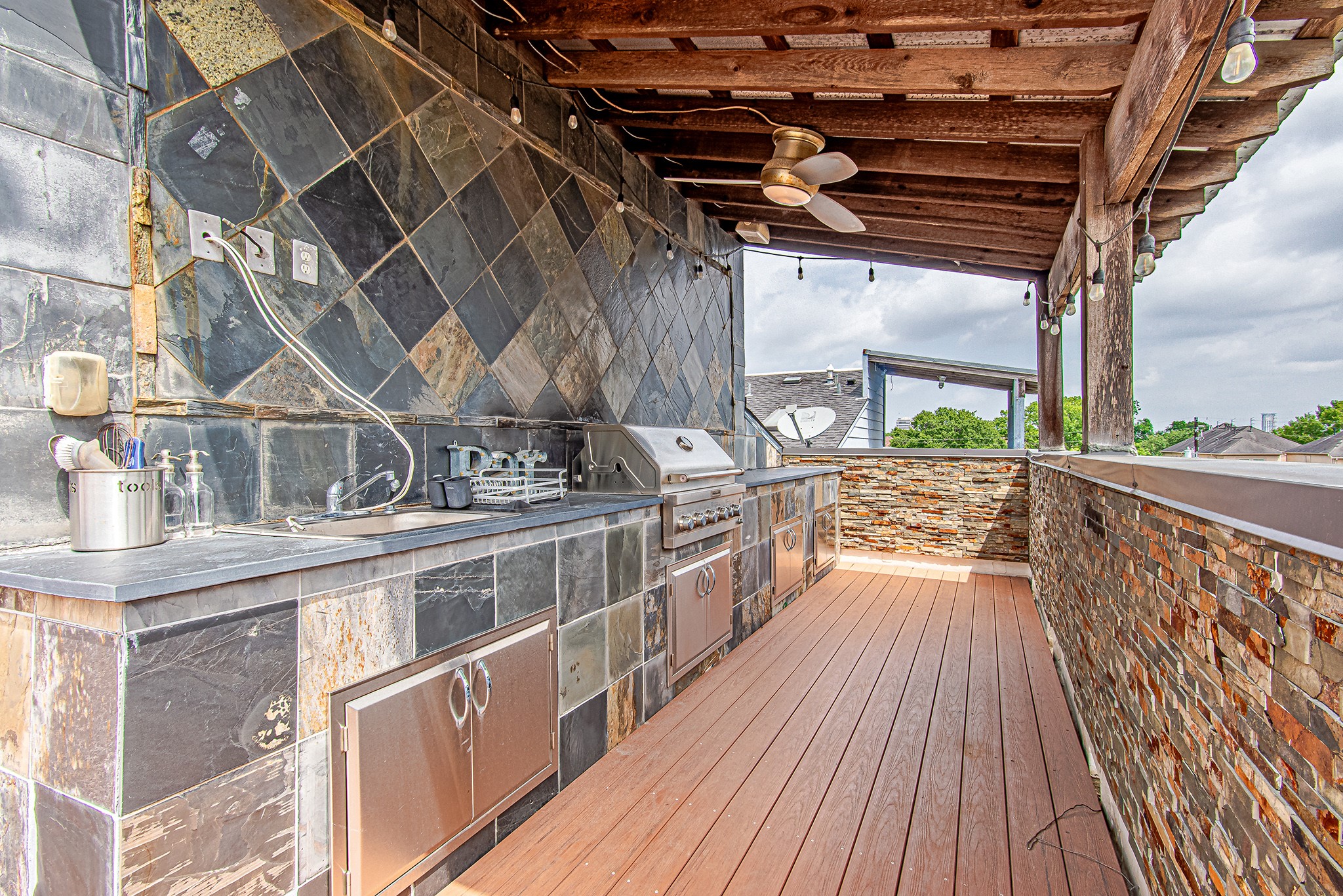 2025 Colquitt Street, Unit E Houston, TX 77098 - Photo 4 of 29 Outdoor covered patio with built-in grill, perfect for entertaining.