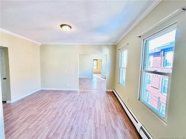 a view of hallway with wooden floor