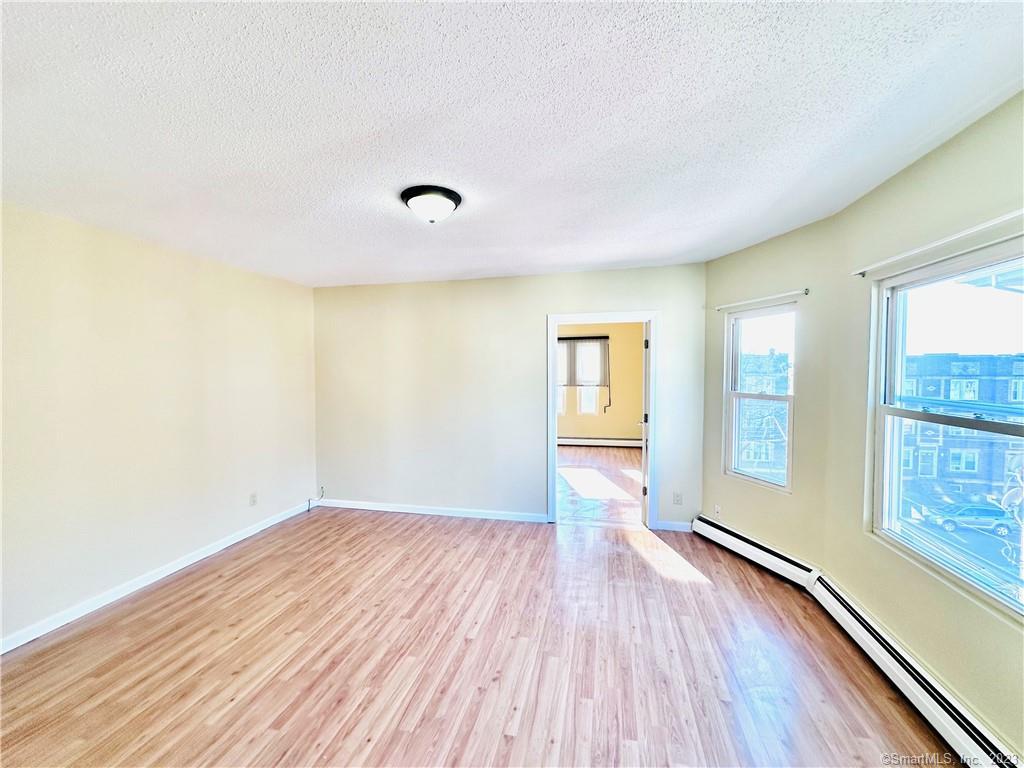 398 Park Street, Unit 3 New Britain, CT 06051 - Photo 2 of 17 wooden floor in an empty room with a window