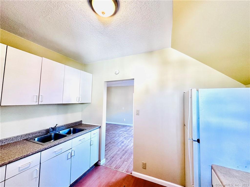 398 Park Street, Unit 3 New Britain, CT 06051 - Photo 5 of 17 a kitchen with a sink and cabinets